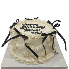 White anniversary cake with black ribbons and the inscription Happy Birthday 18 – Ф1833