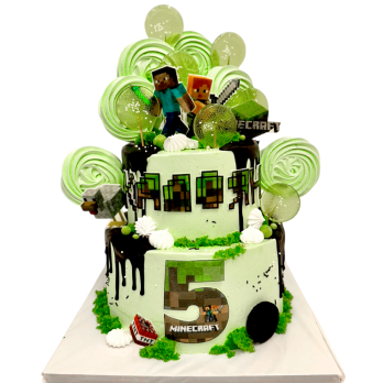 A two-tier Minecraft style cake with chocolate drip, TNT element, green cream rosettes and pixel characters and objects.