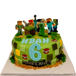 Green Minecraft kids cake, printed characters and 3D block “grass” and Creeper.