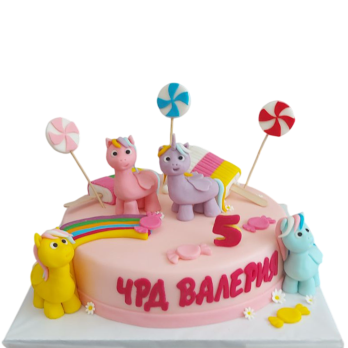 Pink children's cake F1734 with three unicorns made of sugar fondant, a colorful rainbow, candies and pastel lollipops